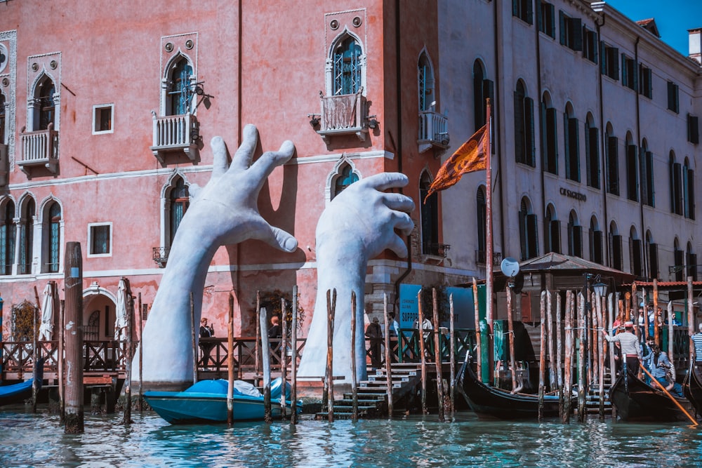 hand statue on body of water