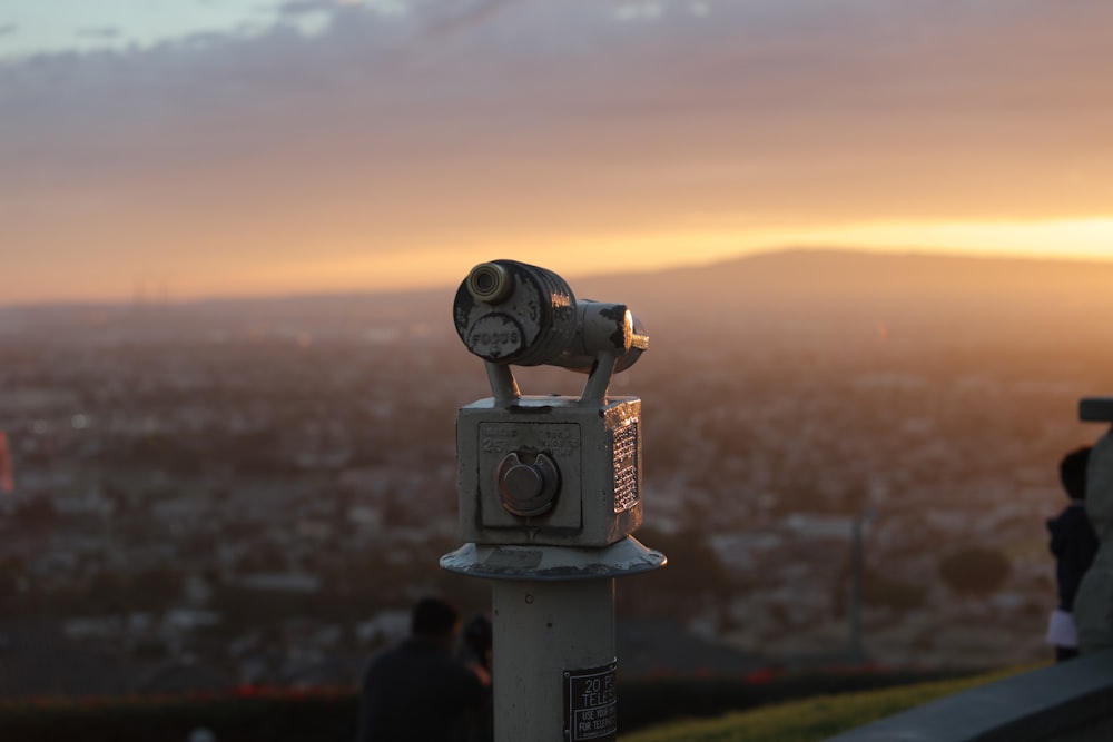 gray metal telescope during orange sunset