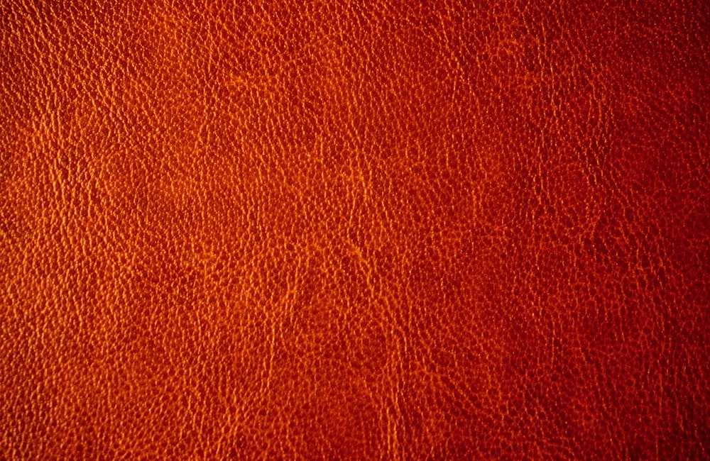 a close up of a red leather texture