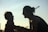 A silhouette of a smiling adult and a child facing each other, capturing a moment of joy and connection in the soft glow of twilight.