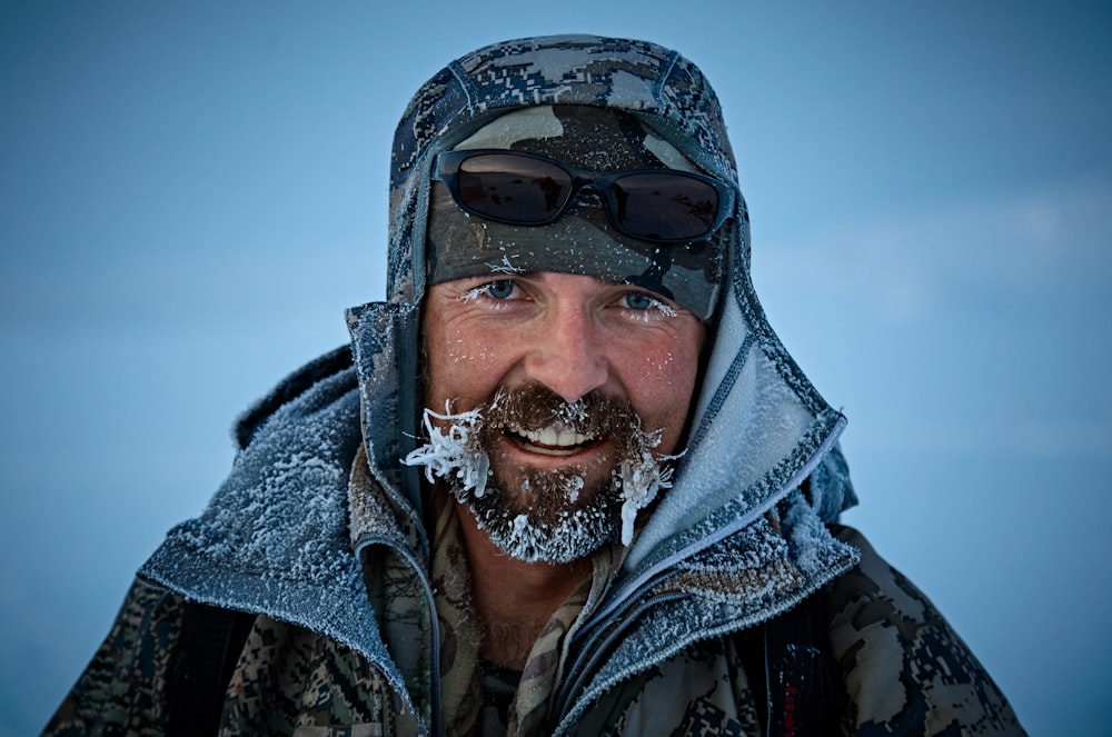 man in grey and black jacket with frost bites