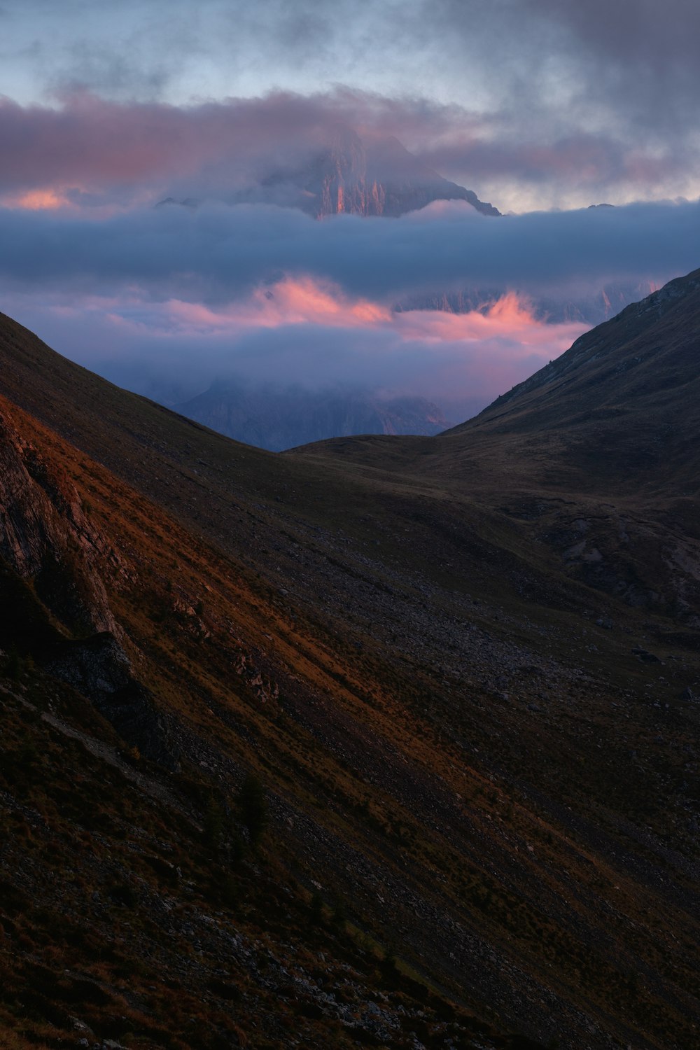 mountain under cloudy skies