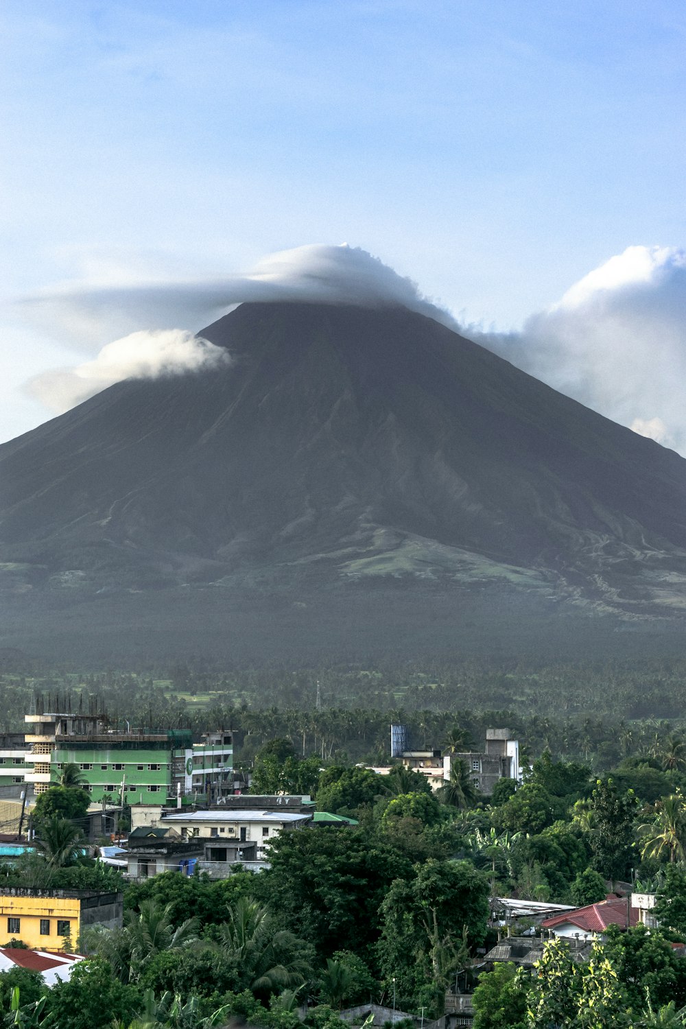 white cloud on cone shaped volcano