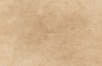 a beige background with a rough texture