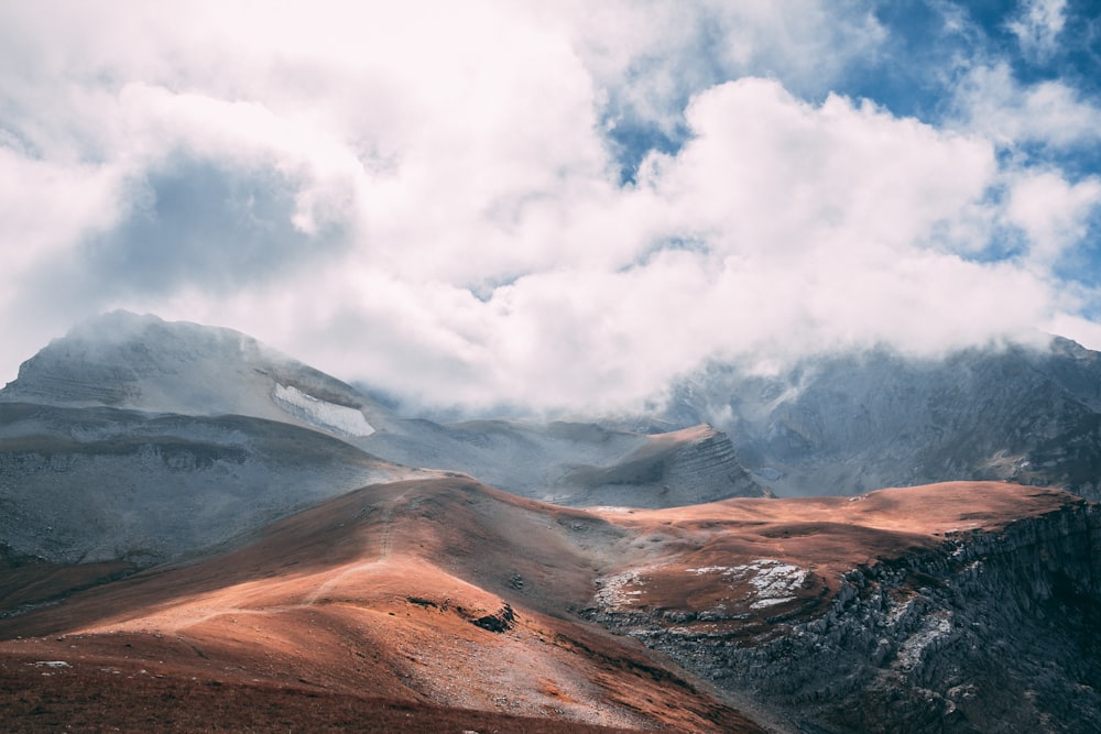 brown mountain under white cloudy sky