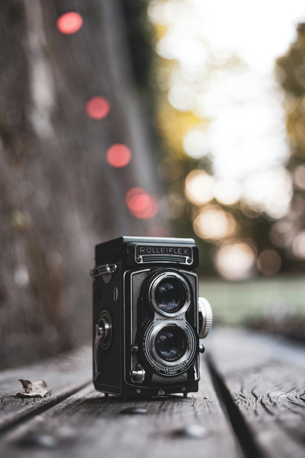 vintage black Rollerflex camera on gray wooden surface selective focus photography