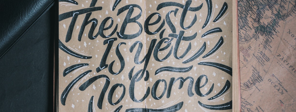 the best is yet to come-printed board beside white pen