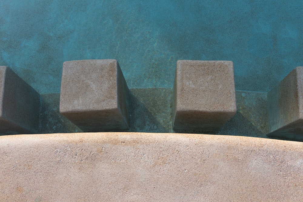 a close up of concrete blocks near a pool