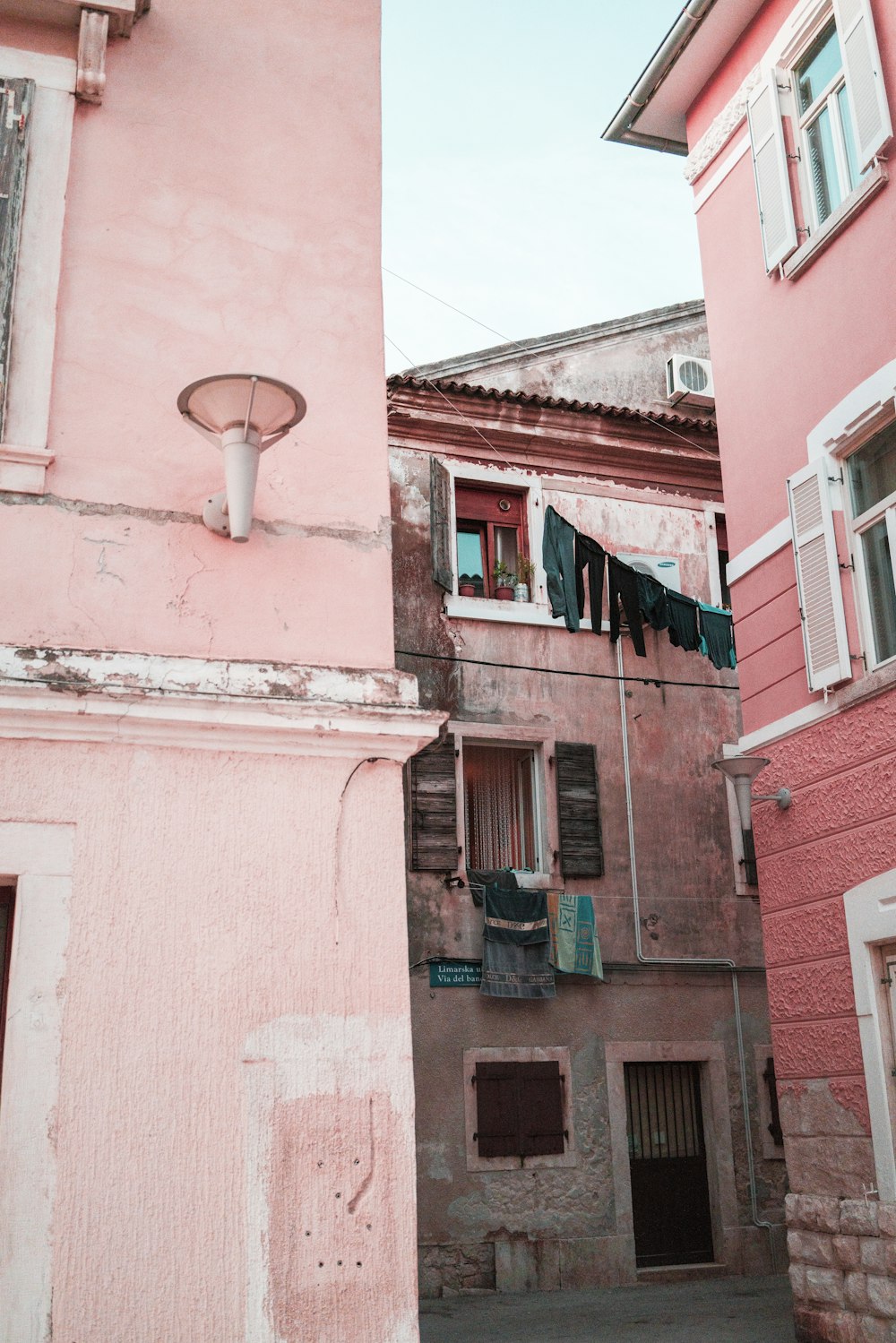 alley near pink high-rise building