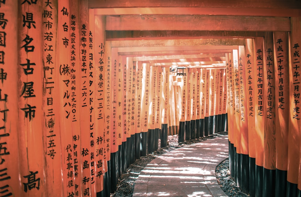 a row of orange and black columns with writing on them