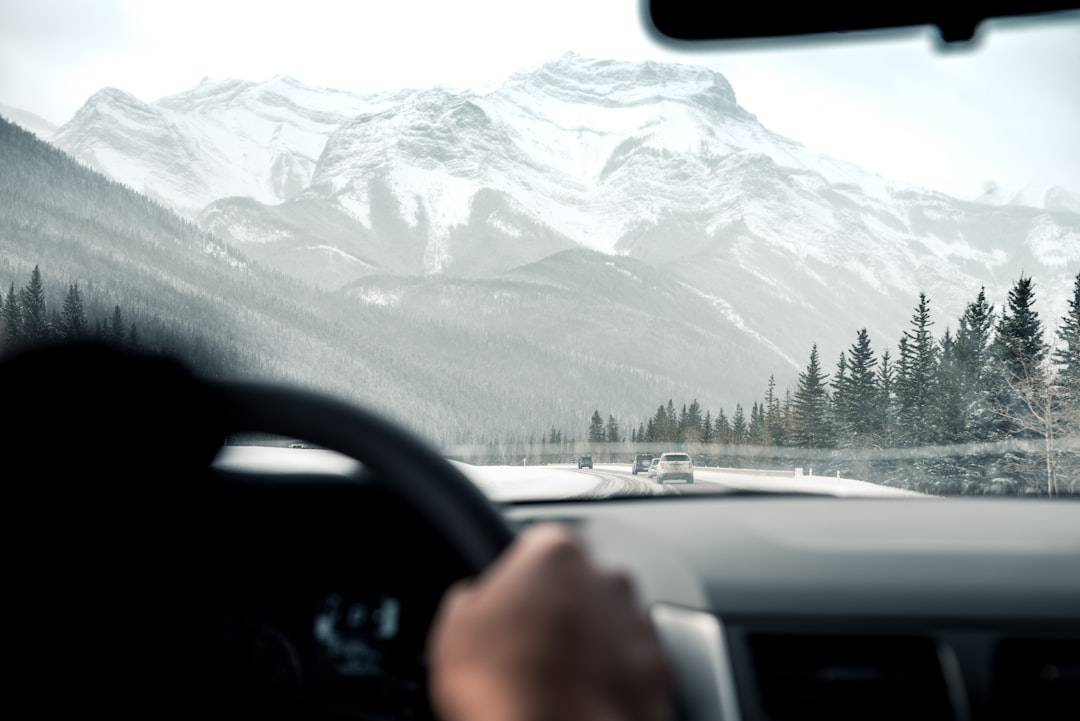 person driving facing through grey mountain
