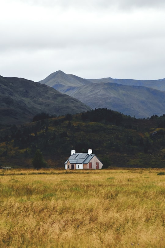 white house with mountain background in Scottish Highlands United Kingdom