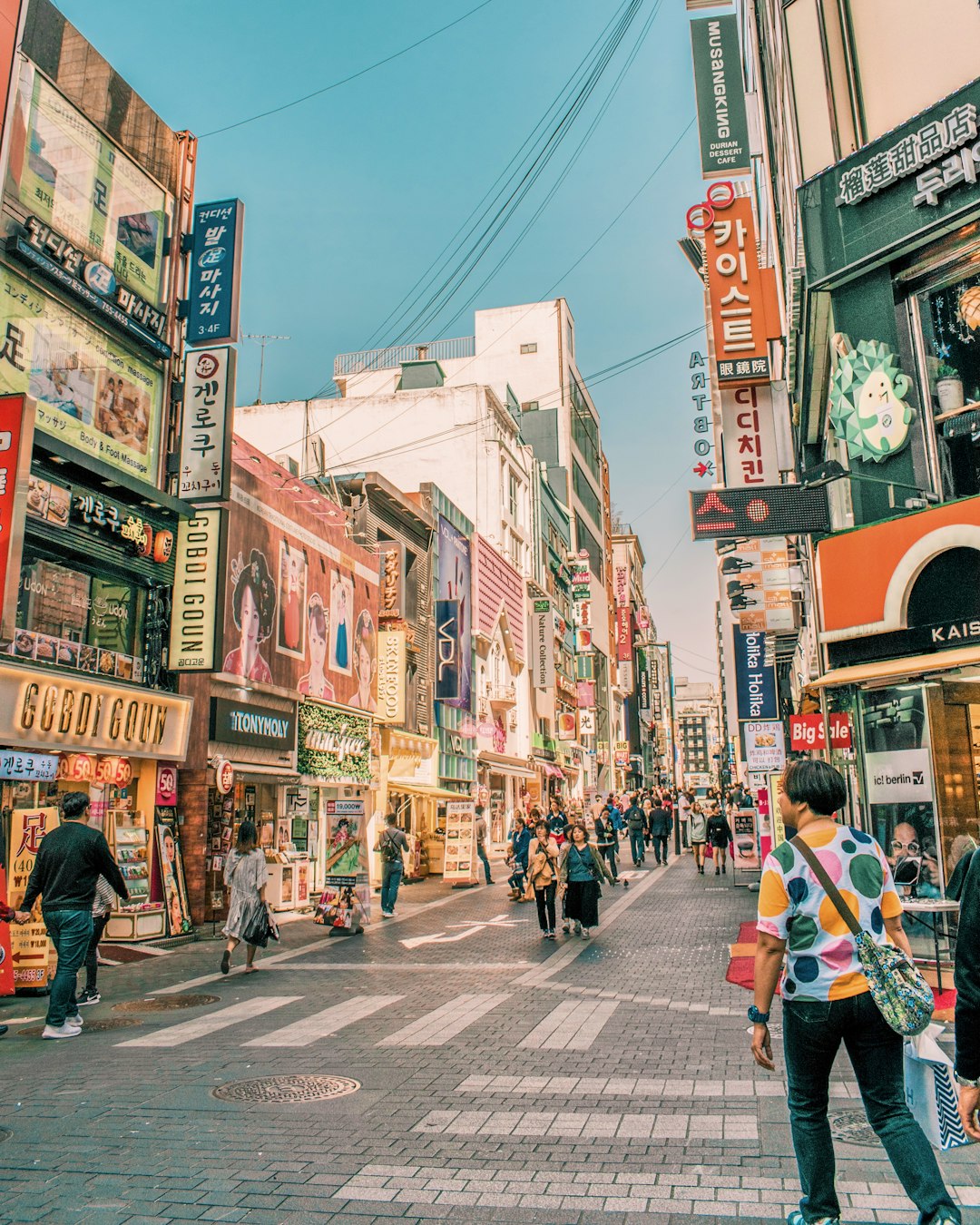 people walking on road surrounded by buildings