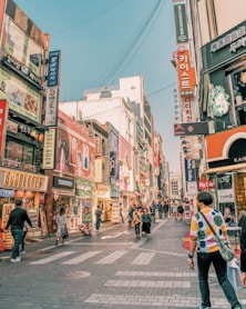 people walking on road surrounded by buildings