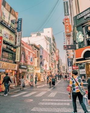 people walking on road surrounded by buildings