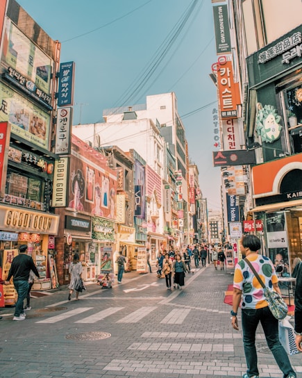 people walking on road surrounded by buildings