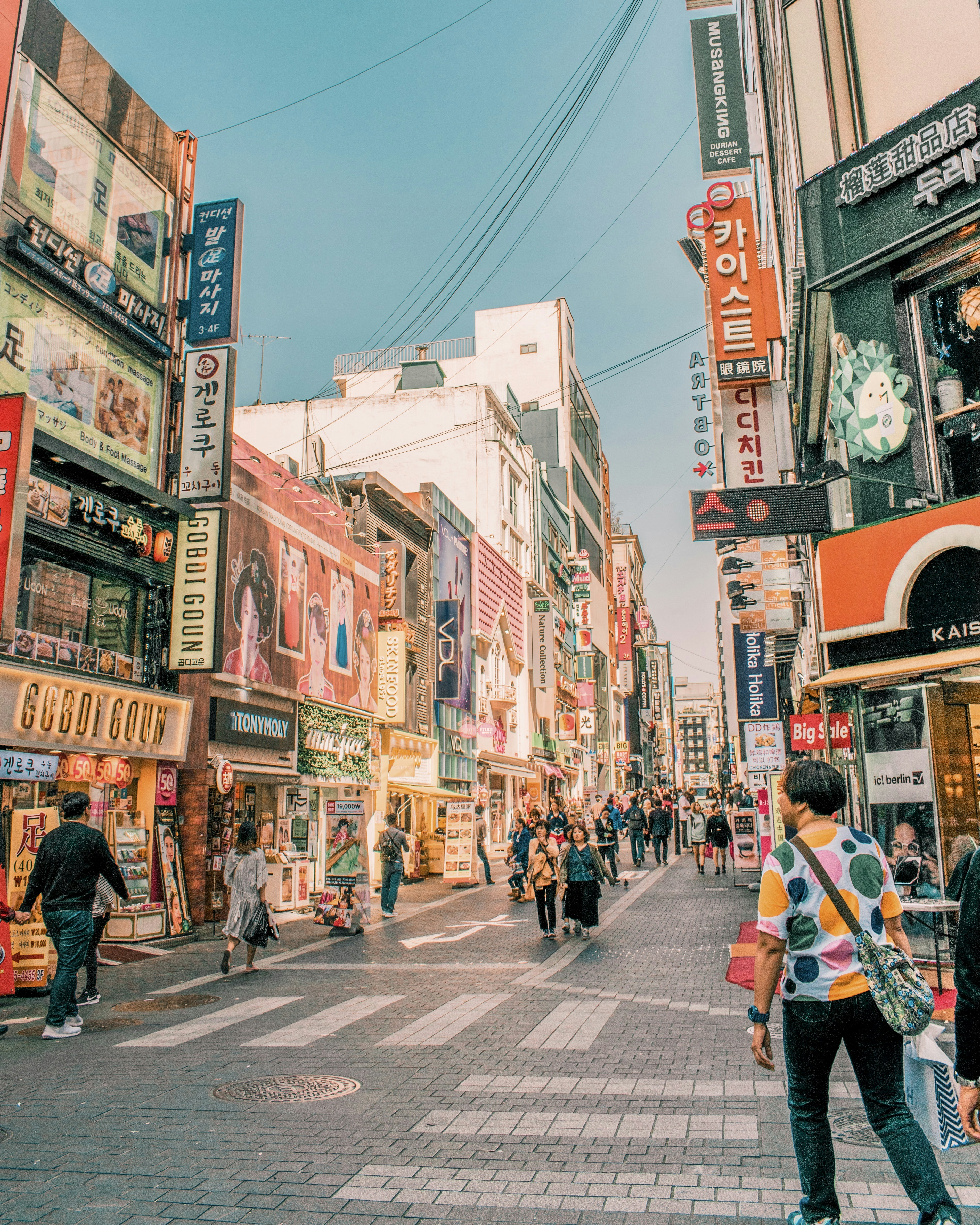 people walking on road surrounded by buildings