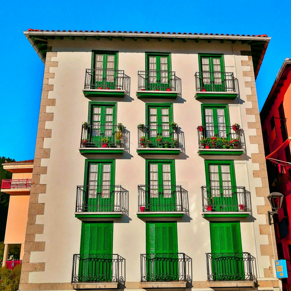 brown and green painted building under blue sky