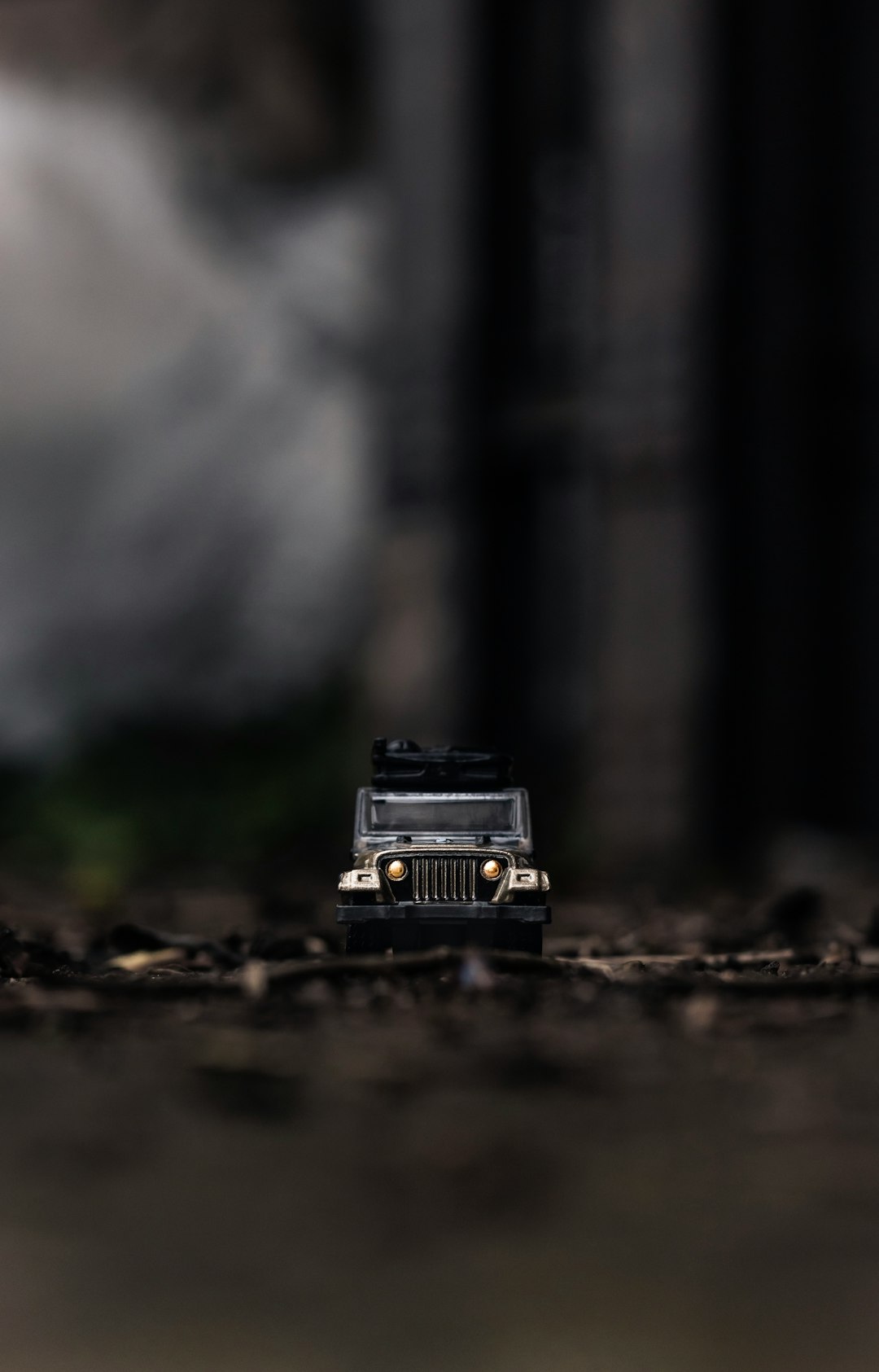 tilt shift lens photography of black Jeep toy