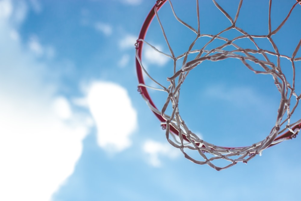 red basketball hoop under blue sky during daytime
