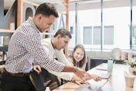 A team collaborating over software development plans on a laptop.
