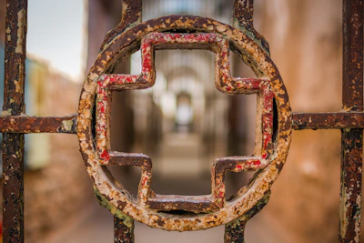 Detail of a freshly painted steel gate showcasing smooth, glossy red paint