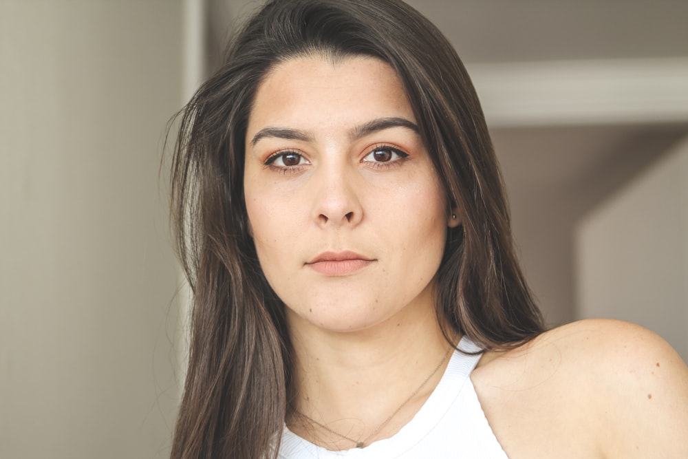 selective focus photo of woman with white top