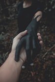 A close-up of hands holding a symbolic blood over intent ritual during a community event.