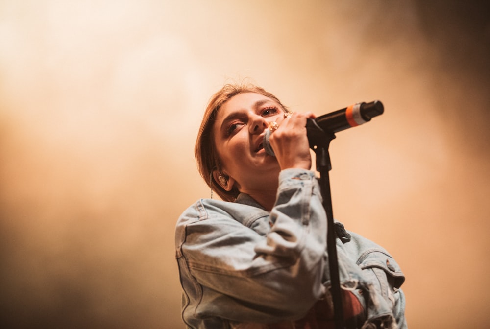 woman holding black microphone