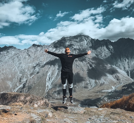 man arms wide open in გერგეტის სამება Georgia