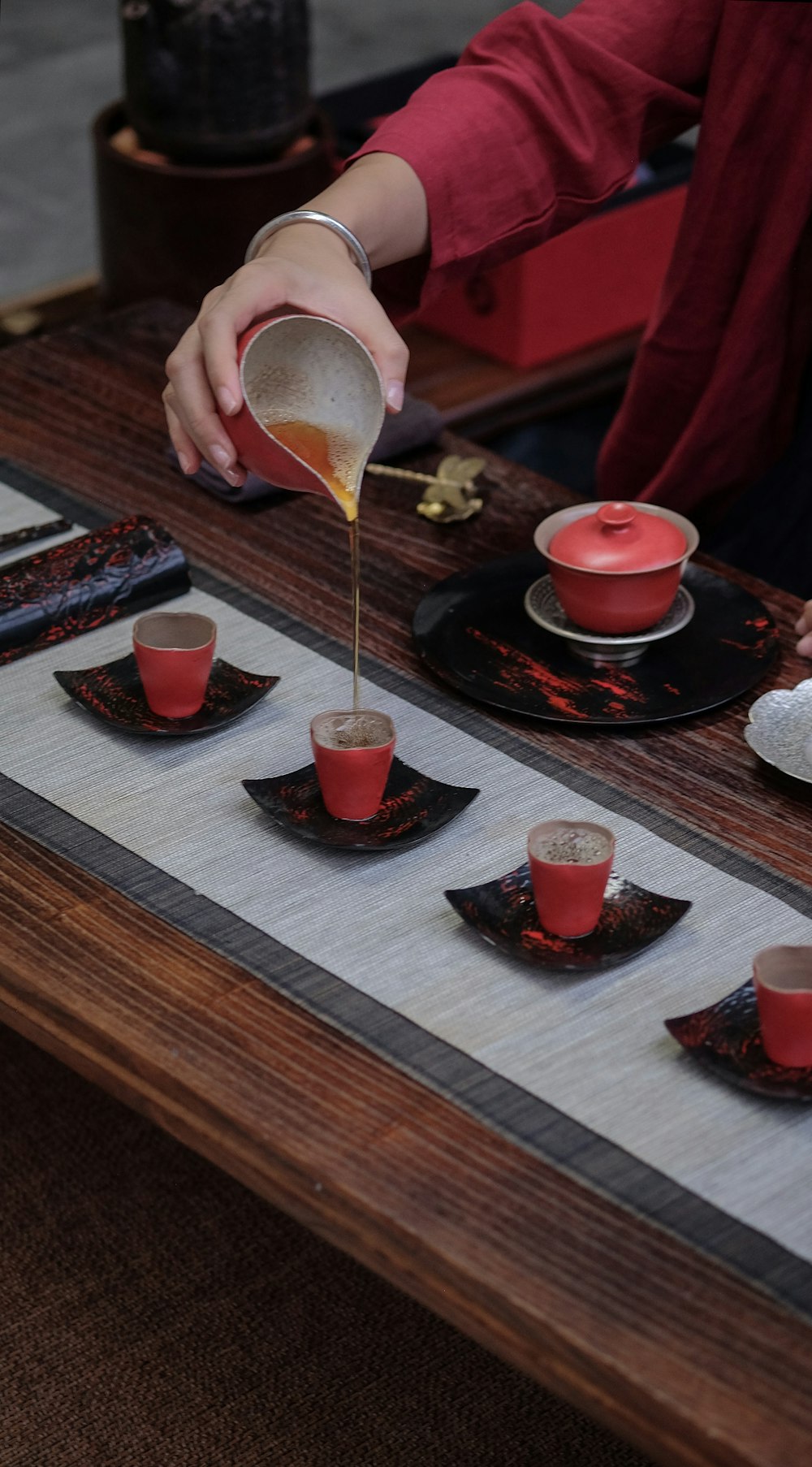 person pouring honey on cup