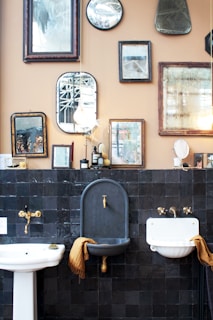three white and gray ceramic sinks beside photo frames