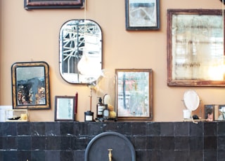 three white and gray ceramic sinks beside photo frames