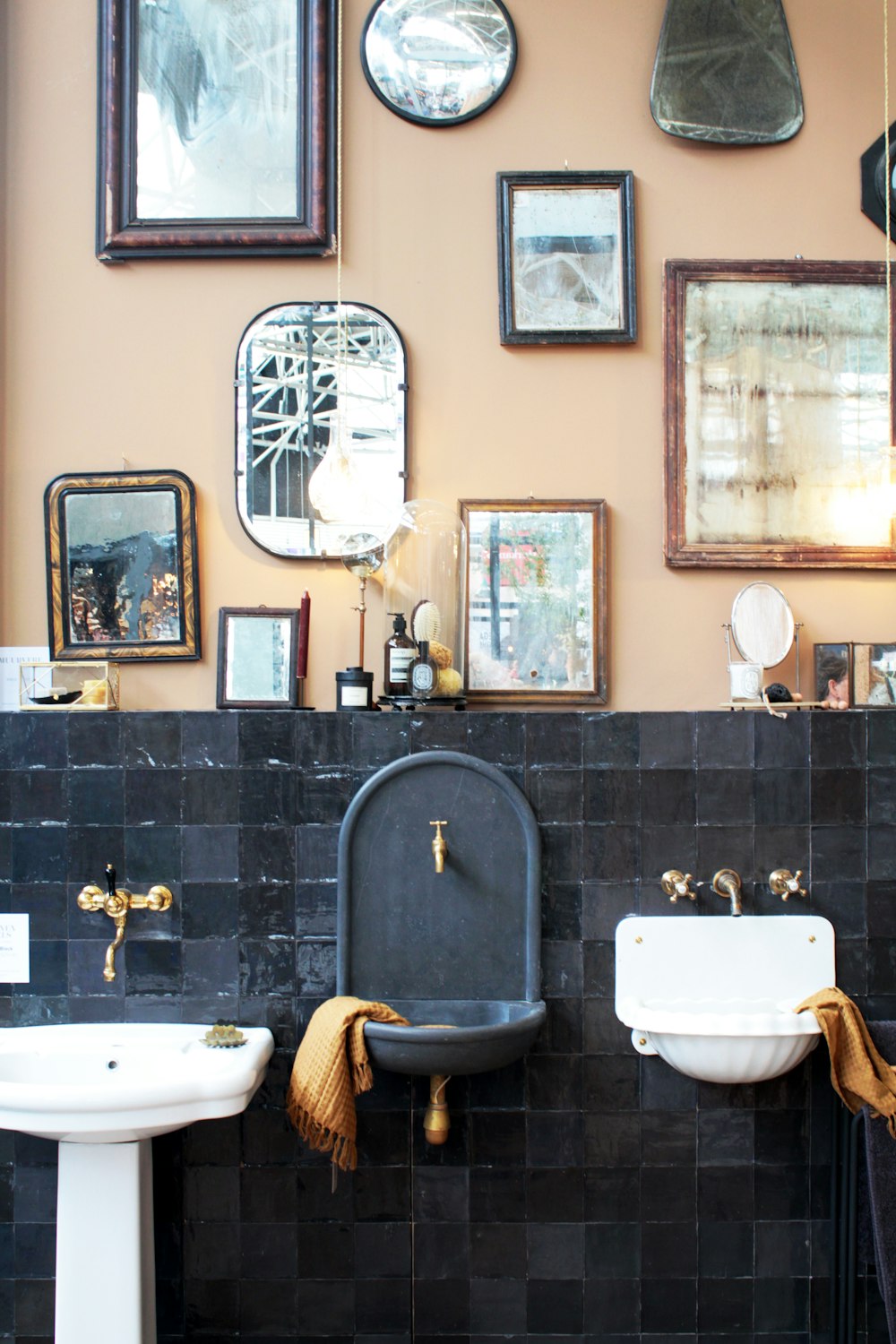 three white and gray ceramic sinks beside photo frames