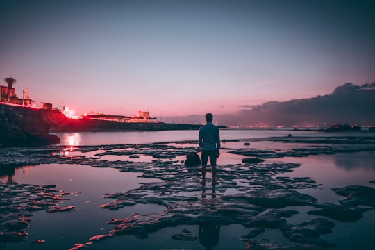 man standing on middle of beach in low tide in Karataş Turkey