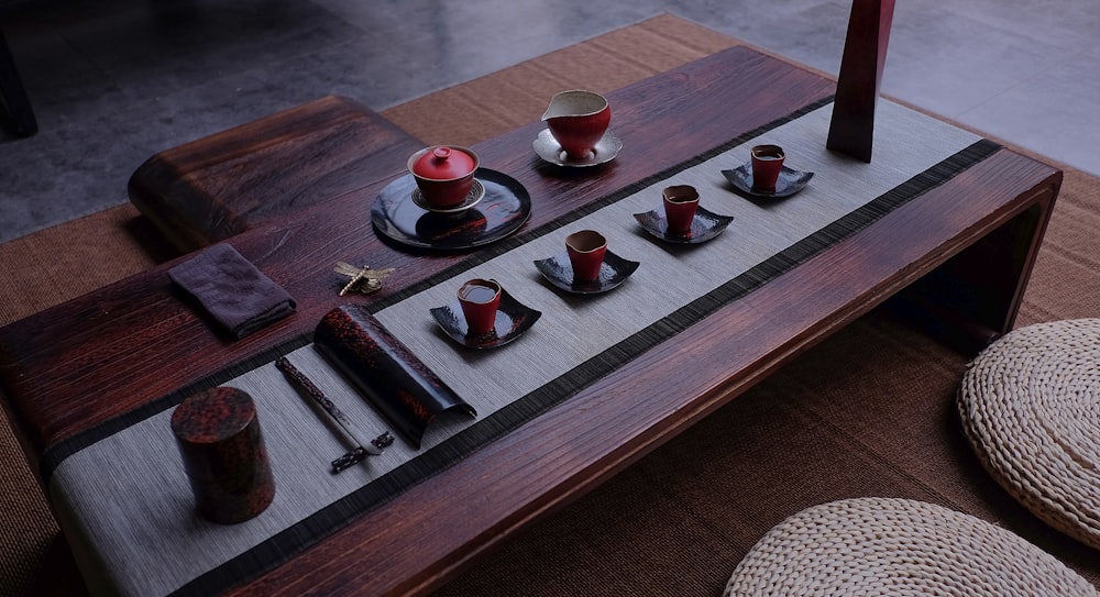 red ceramic tea set on wooden table