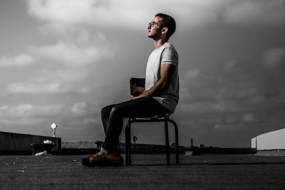 man sitting on chair during daytime