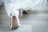 A close-up of elegant high heels on a wooden floor.