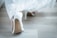 A close-up of elegant high heels on a wooden floor.