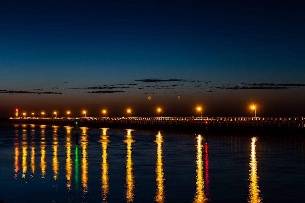 reflection of yellow street light near body of water