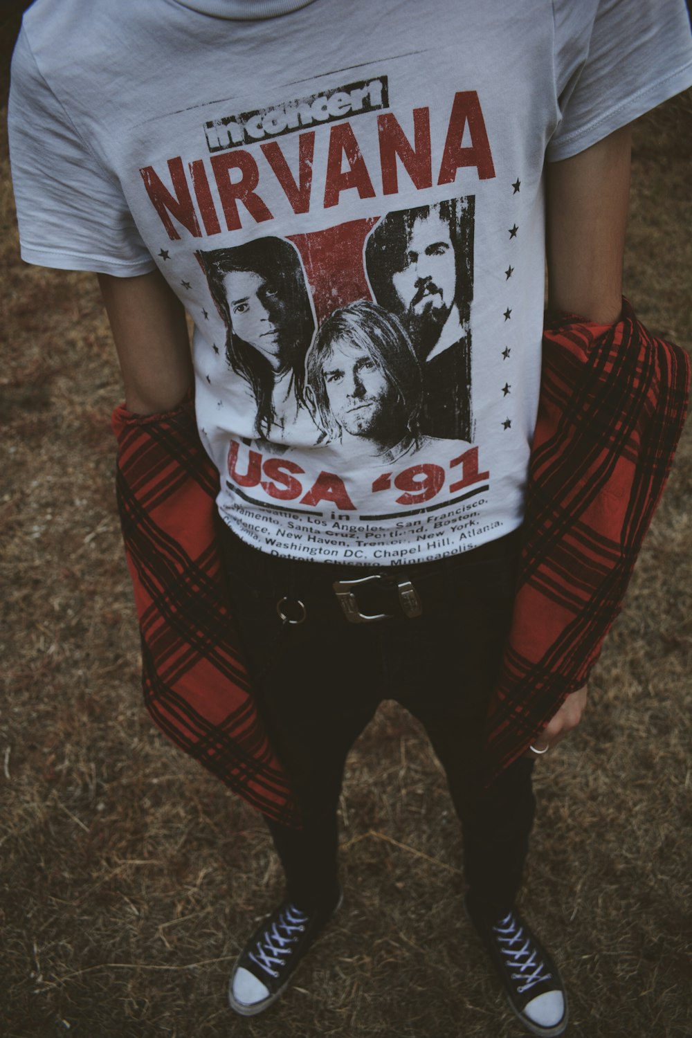 man wearing Nirvana print t-shirt
