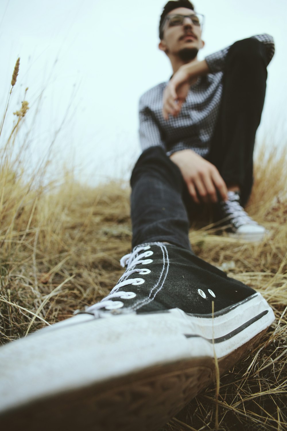 man sitting on green grass