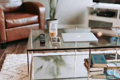 Living room scene showing a TV stand with remote controls and electronic accessories.