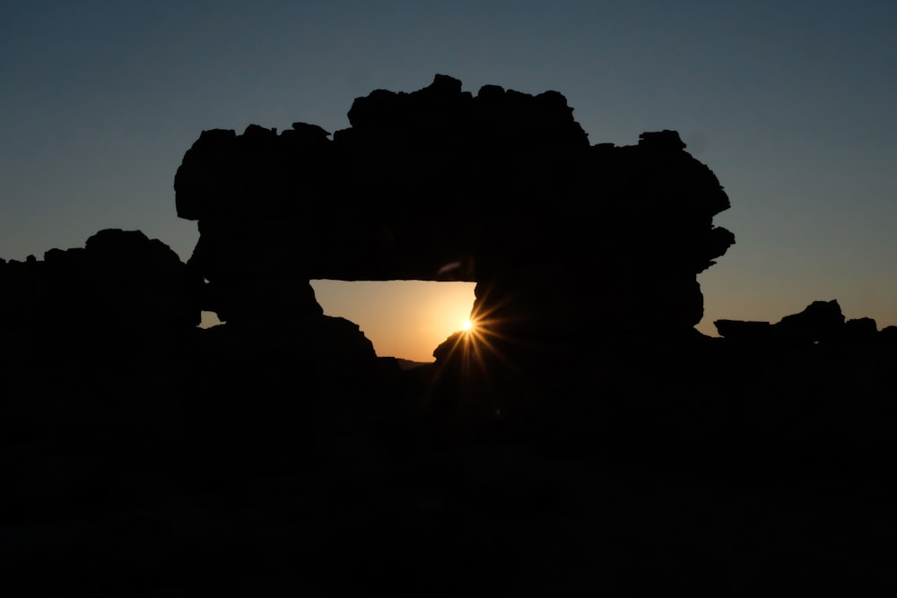 silhouette photography of rock formation during golden hour