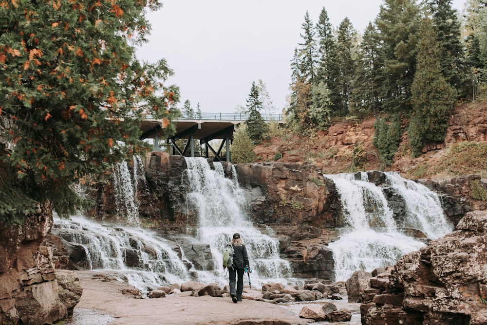 person near waterfalls