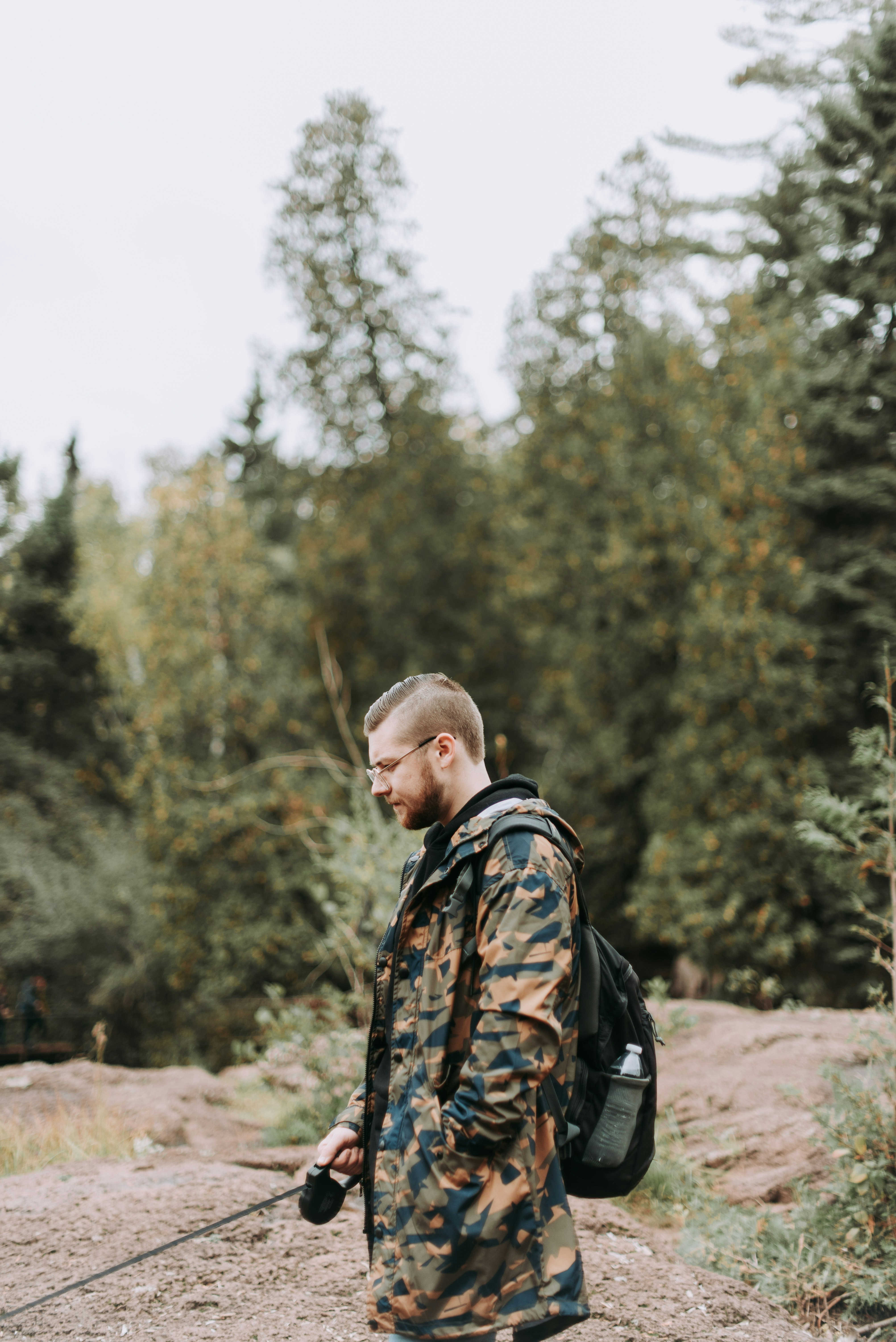 man standing wearing backpack outdoors