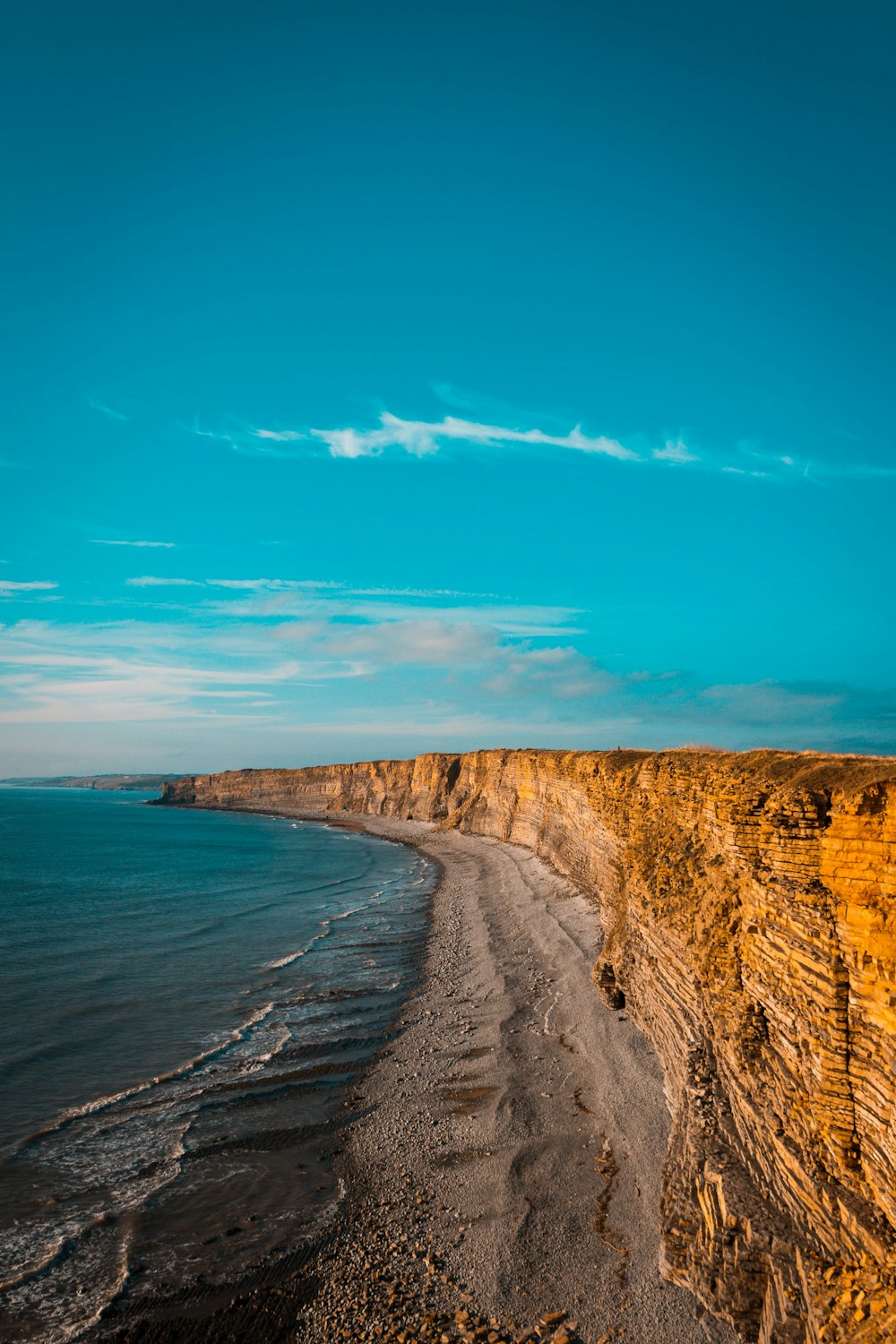 landscape photography of body of water and rock formations