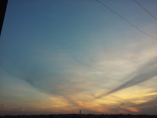 A horizon line blending sky and land with atmospheric layers of color and light.