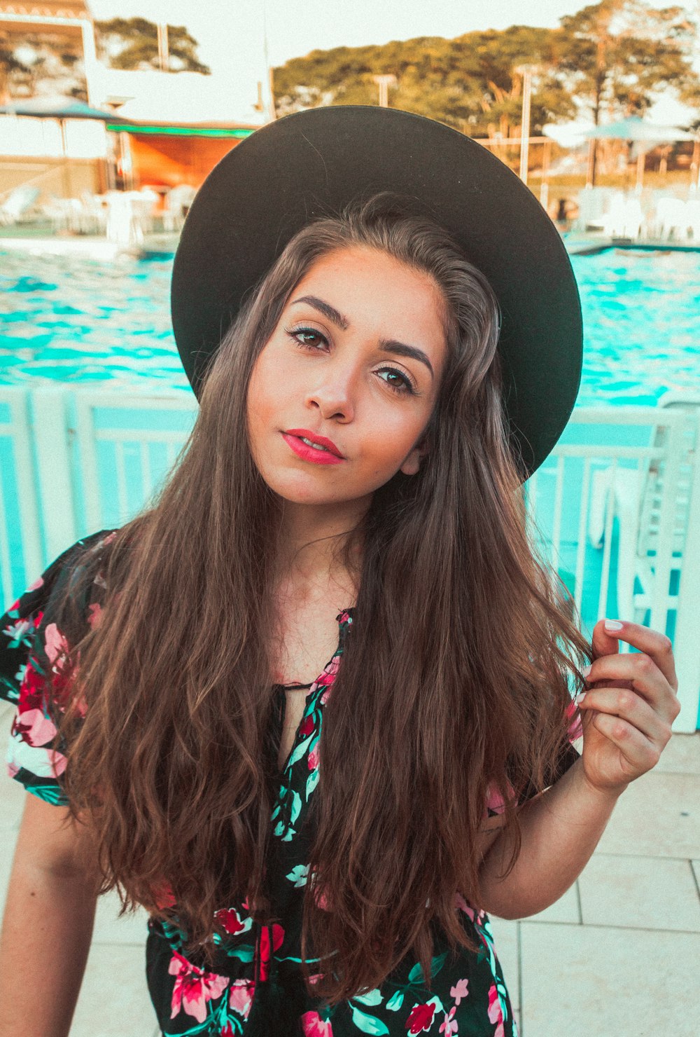 woman wearing red and black floral cap-sleeved dress