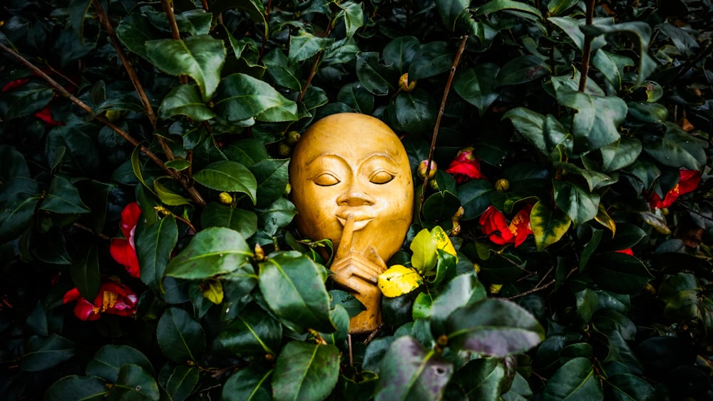 white mask beside plants